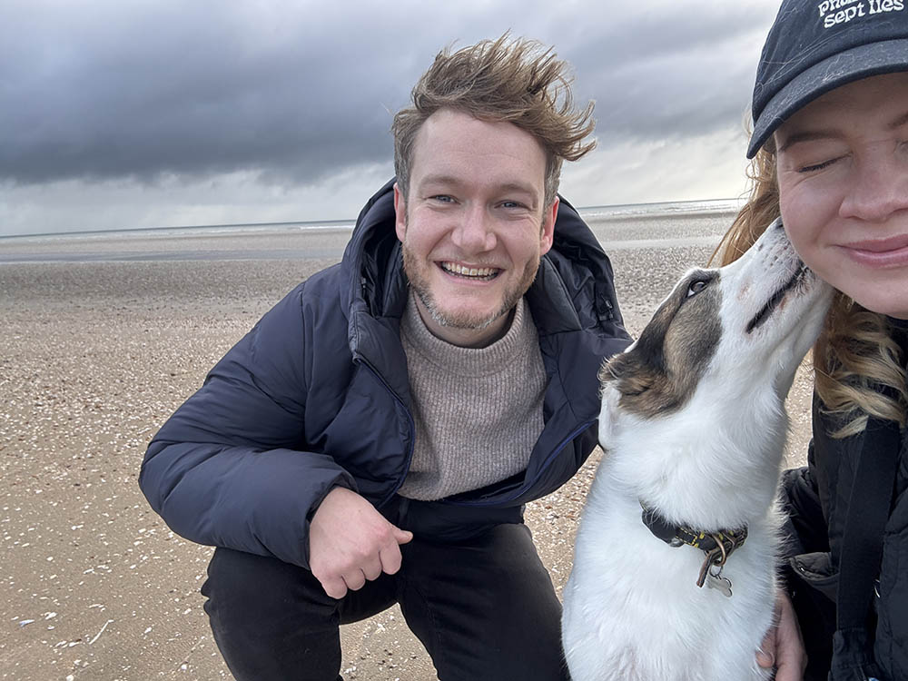 Couple and a dog on the beach
