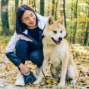 Woman sitting outside with her Akita dog.