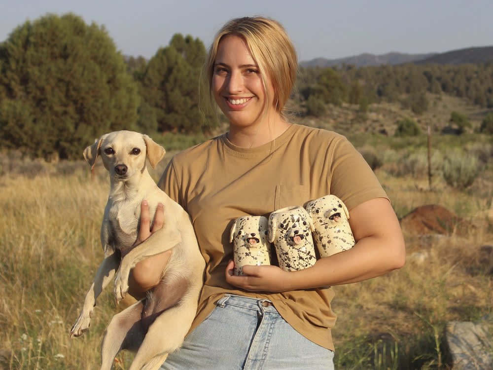 katie kimmel with her dog and three ceramic vases