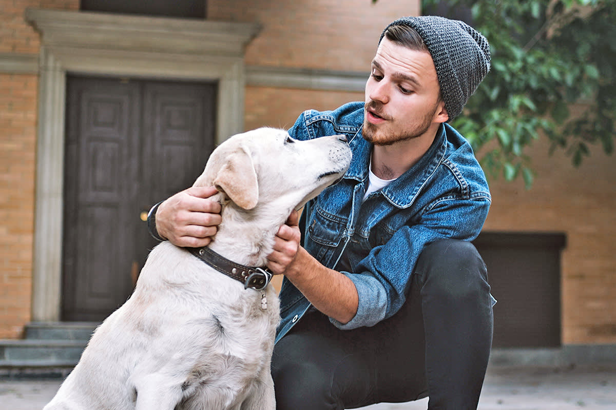 person singing to white dog