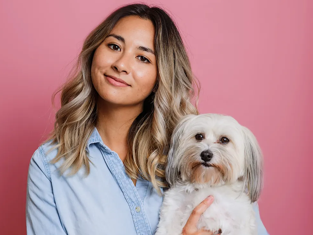 Mia Mercado with her small white dog