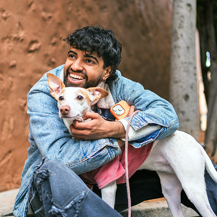 a man poses with a dog