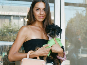 Woman holding a little black dog (Yoko)