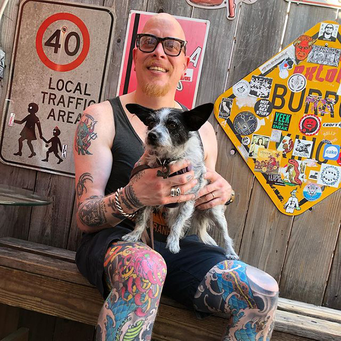 a small black and white dog in an outdoor space in Benders