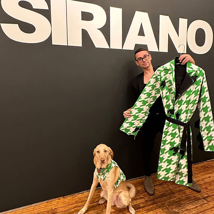Christian Siriano with a small yellow dog