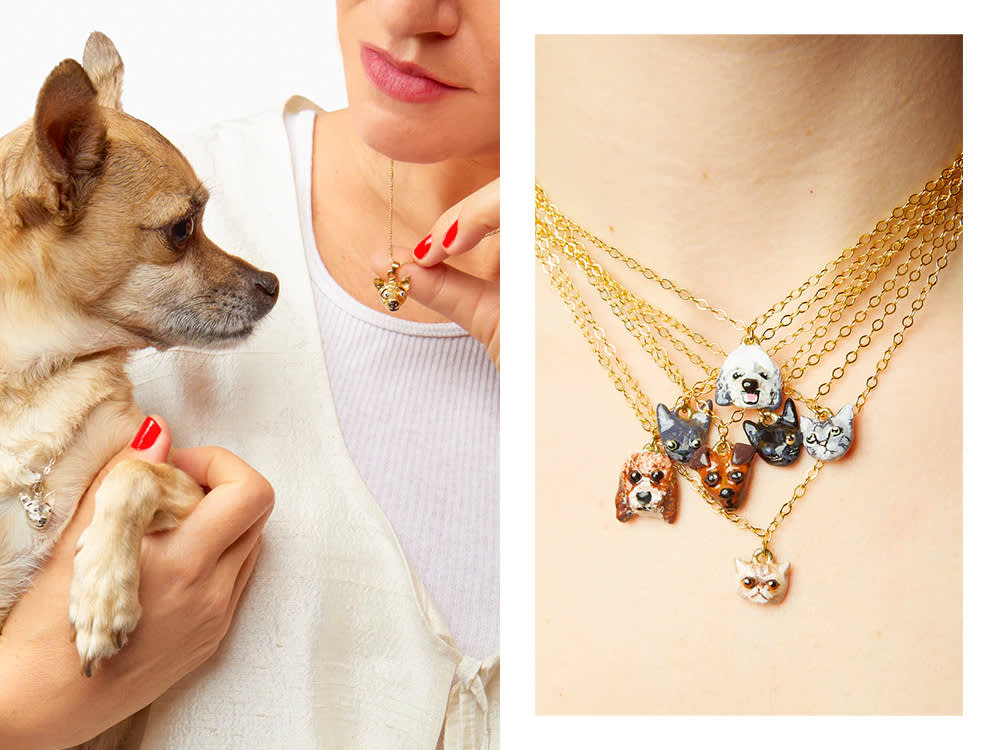 a dog looks at a custom Susan Alexandra pet necklace; seven custom pet necklaces on a person's neck