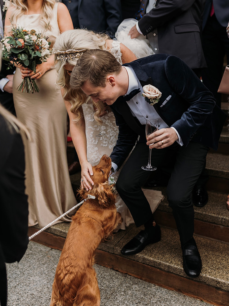 Bride and groom on their wedding day with their dog