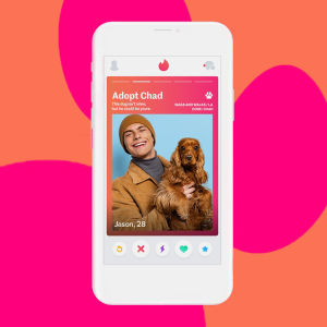 Mock up of a white smartphone with an image on the screen of Tinder's new Rescue Match feature that reads "Adopt Chad" with a picture of a smiling man holding a brown dog