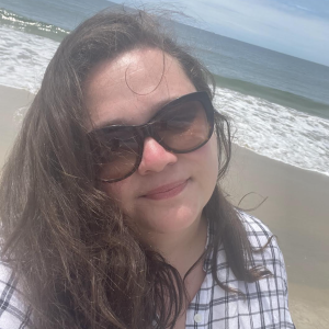 Author Courtney E. Smith on a beach