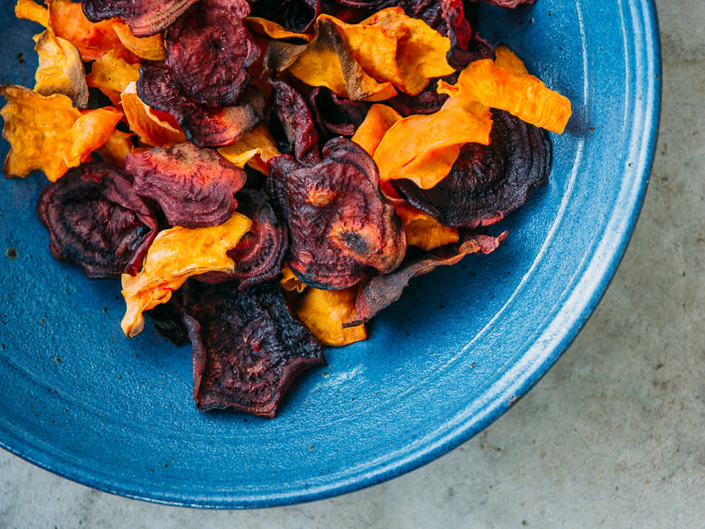 a blue plate of sweet potato chips for dogs