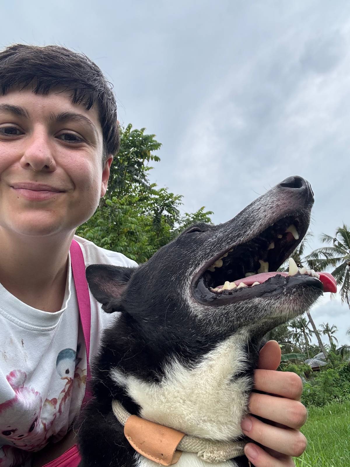 a picture of a person hugging a black dog