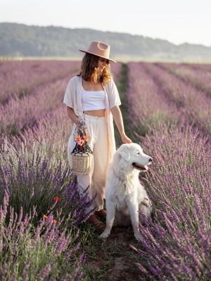 Woman and dog in lavender field.