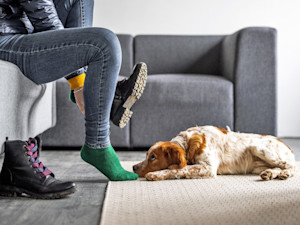 Sad dog staring at someone getting ready to leave their house.