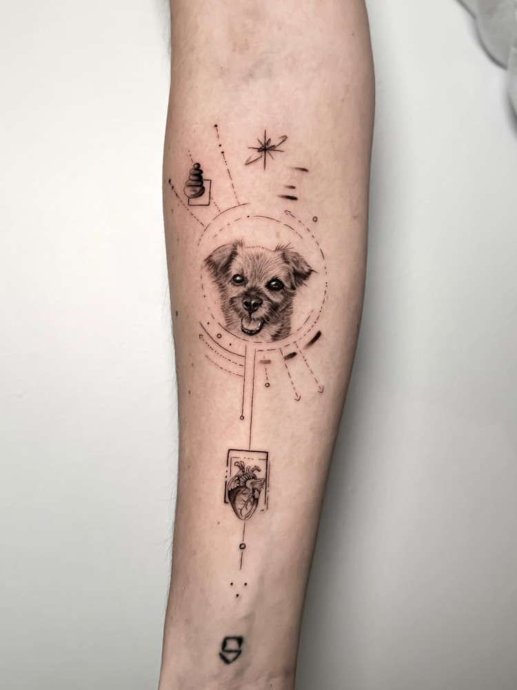 A tattoo of dog with geometric designs around it.