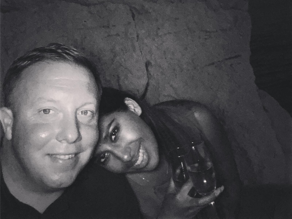 A black and white selfie picture of a man and a woman smiling