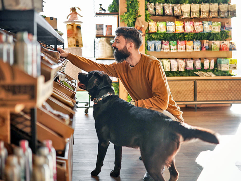 A Young Man and His Pup at the Pet Shop.