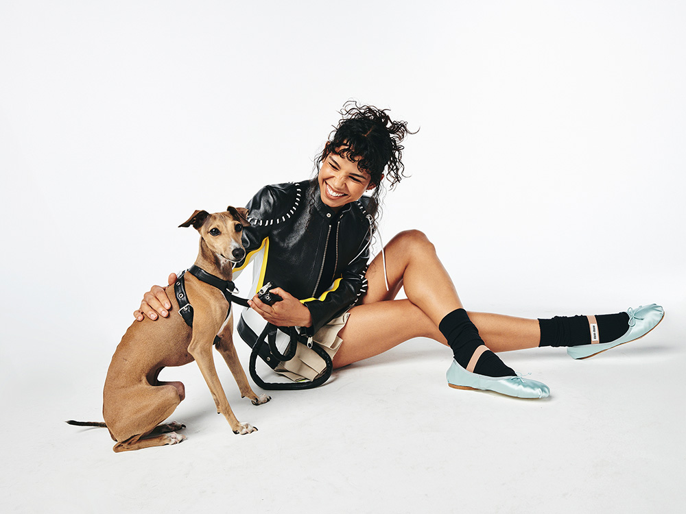 a person on the ground with a small brown dog