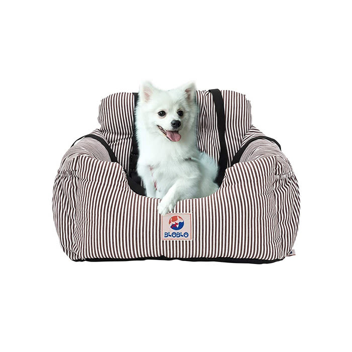 white dog in a pin striped car seat