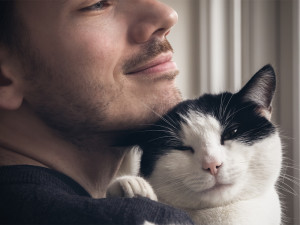 cat snuggling man