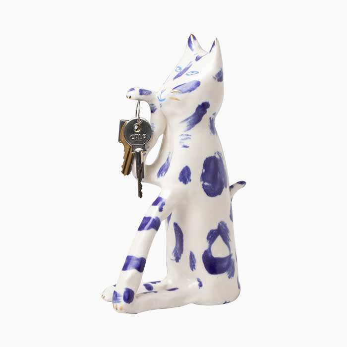 ceramic cat with blue spots holding keys