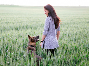 German Shepherd Dog And Woman In Coutryside.
