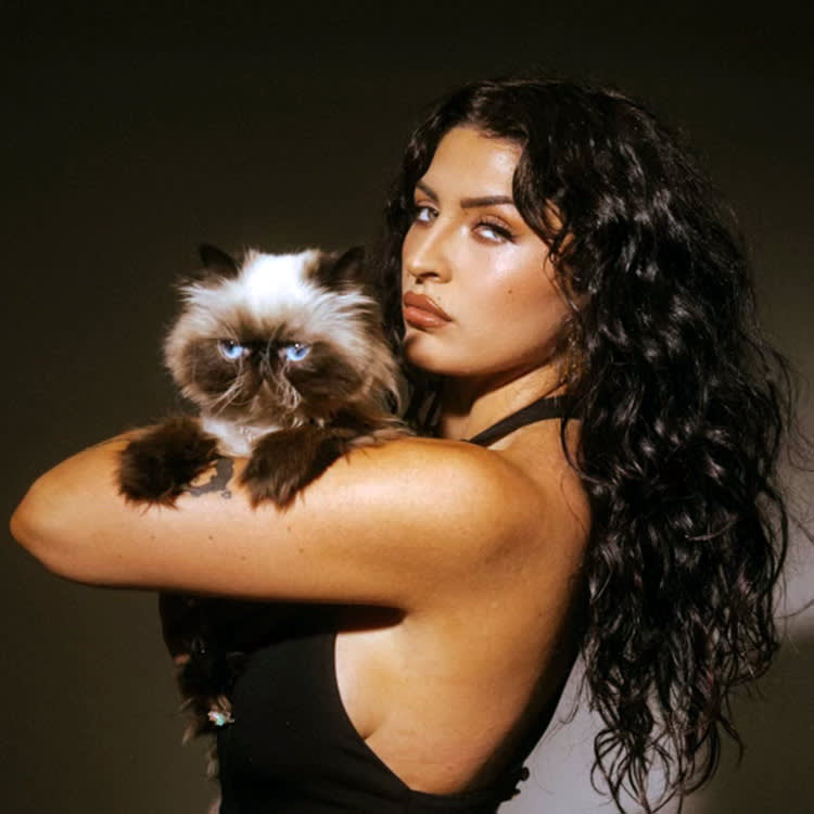 Emmy Meli with her cat, Ruth
