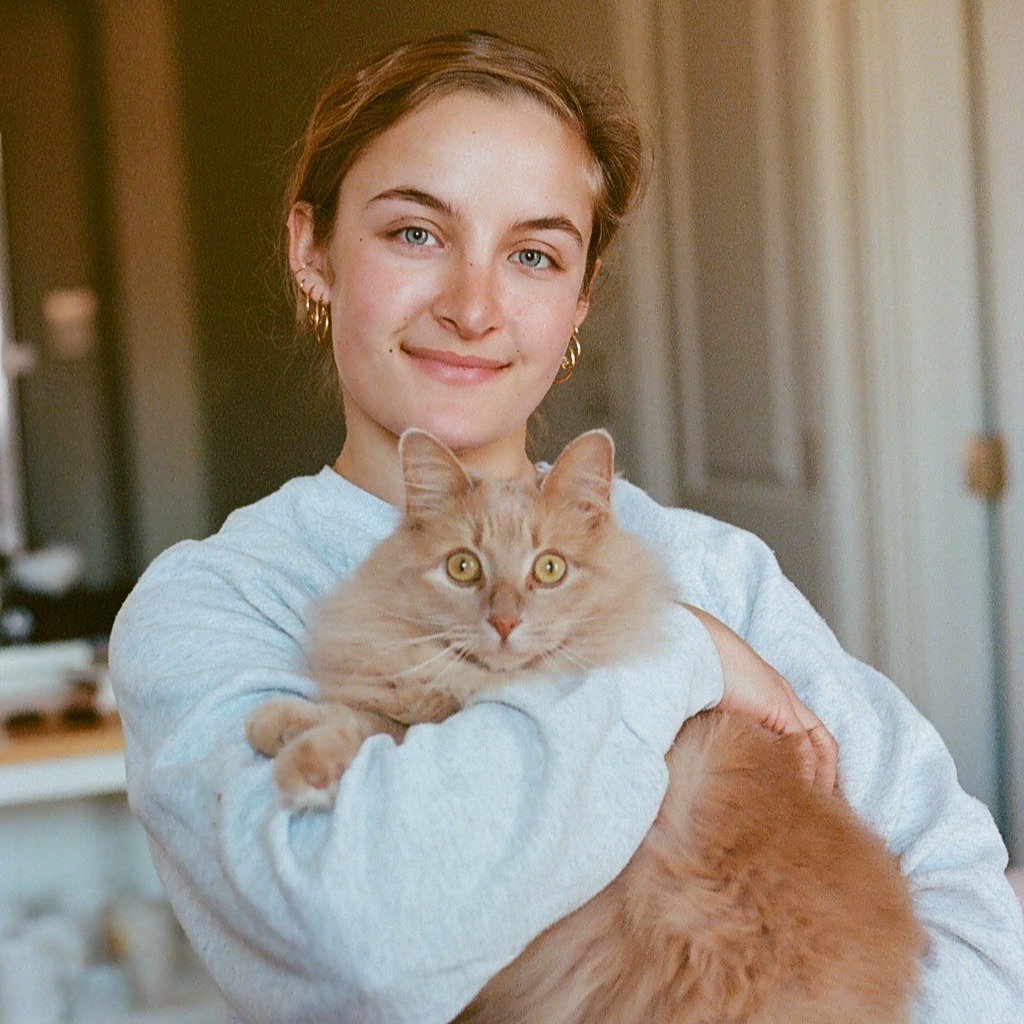 Avery, editor at Kinship, and her cat, Chicken