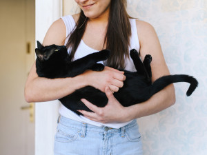 Woman Holding Her Black Cat.
