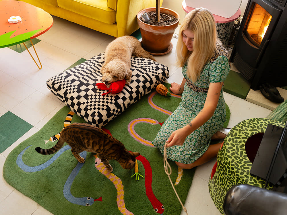 Lorien Stern with her dog and cat on a rug