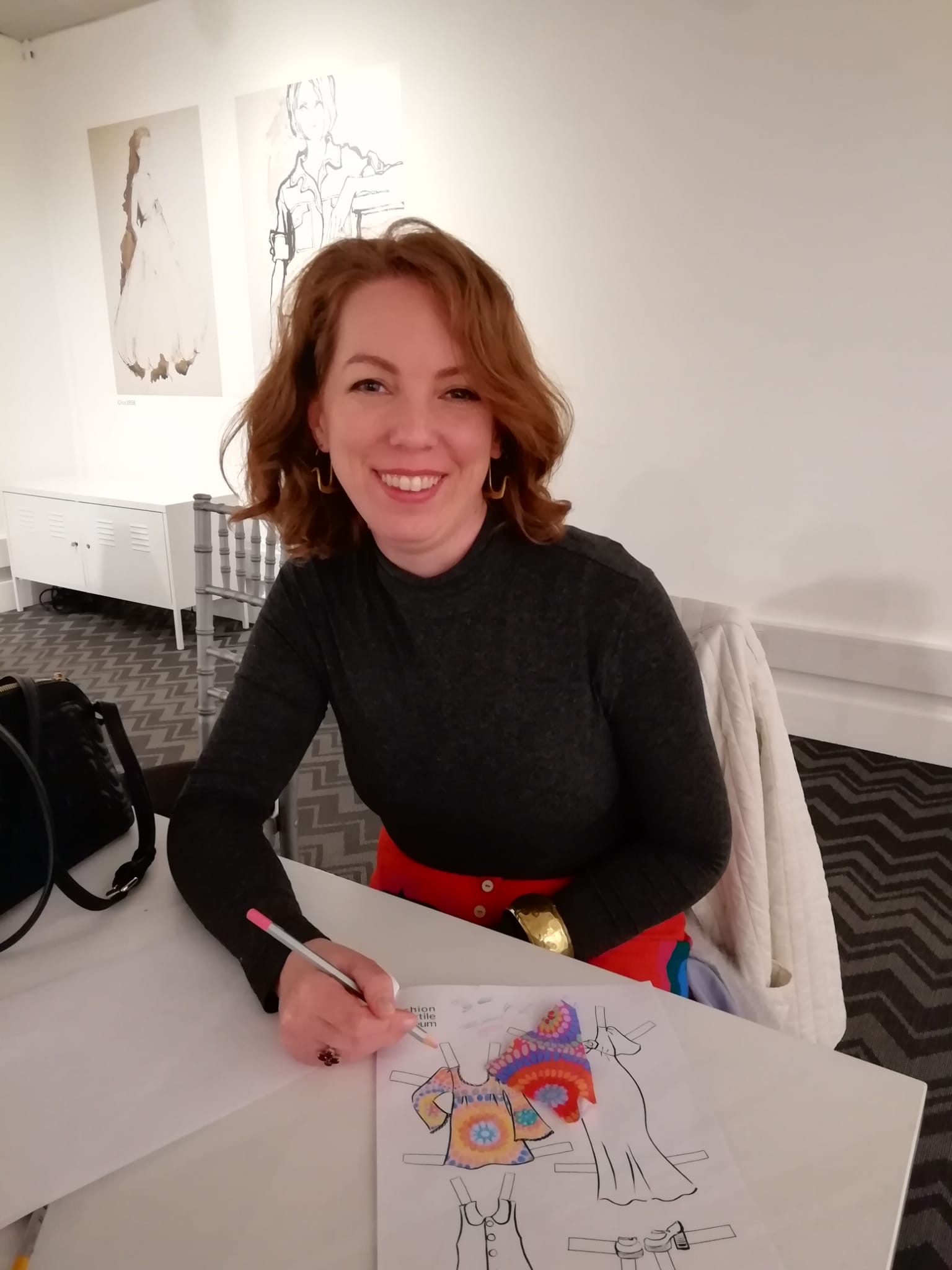 woman with red hair colouring in a picture