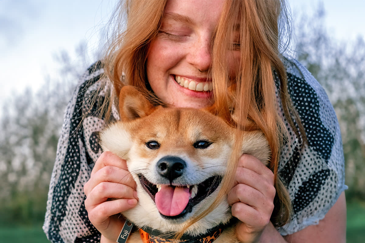 person smiling with their dog