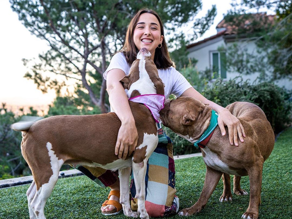 Victoria Lily Shaffer and two large brown dogs