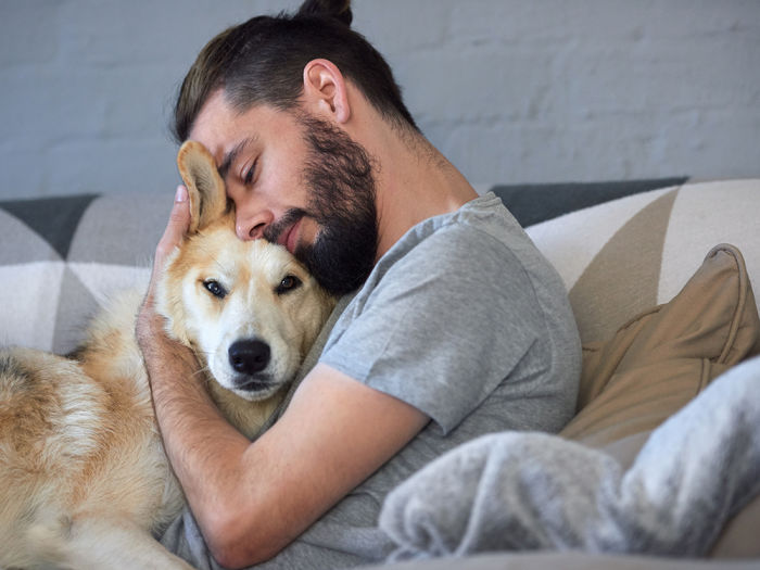 Man hugs his dog to his face