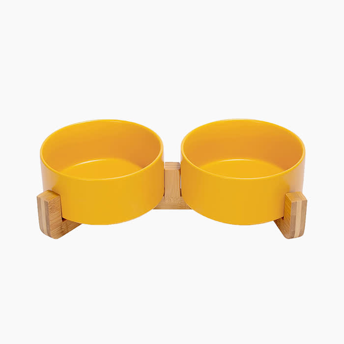 yellow pet bowls on wooden stand