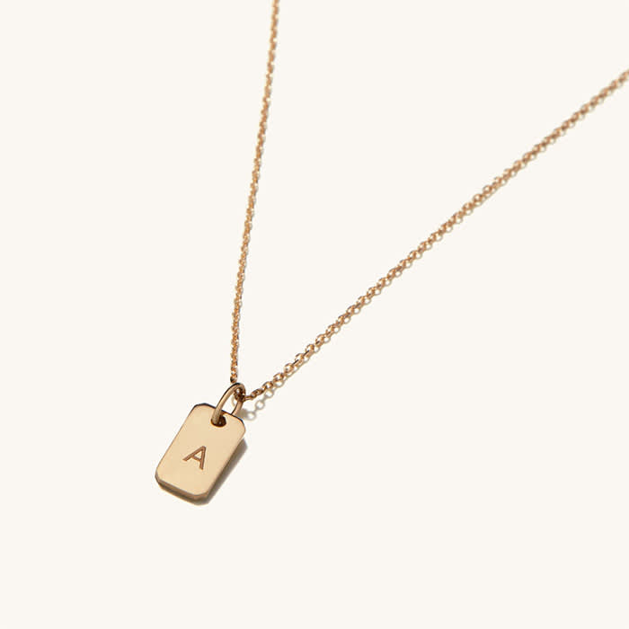 gold tag necklace with "A" engraved