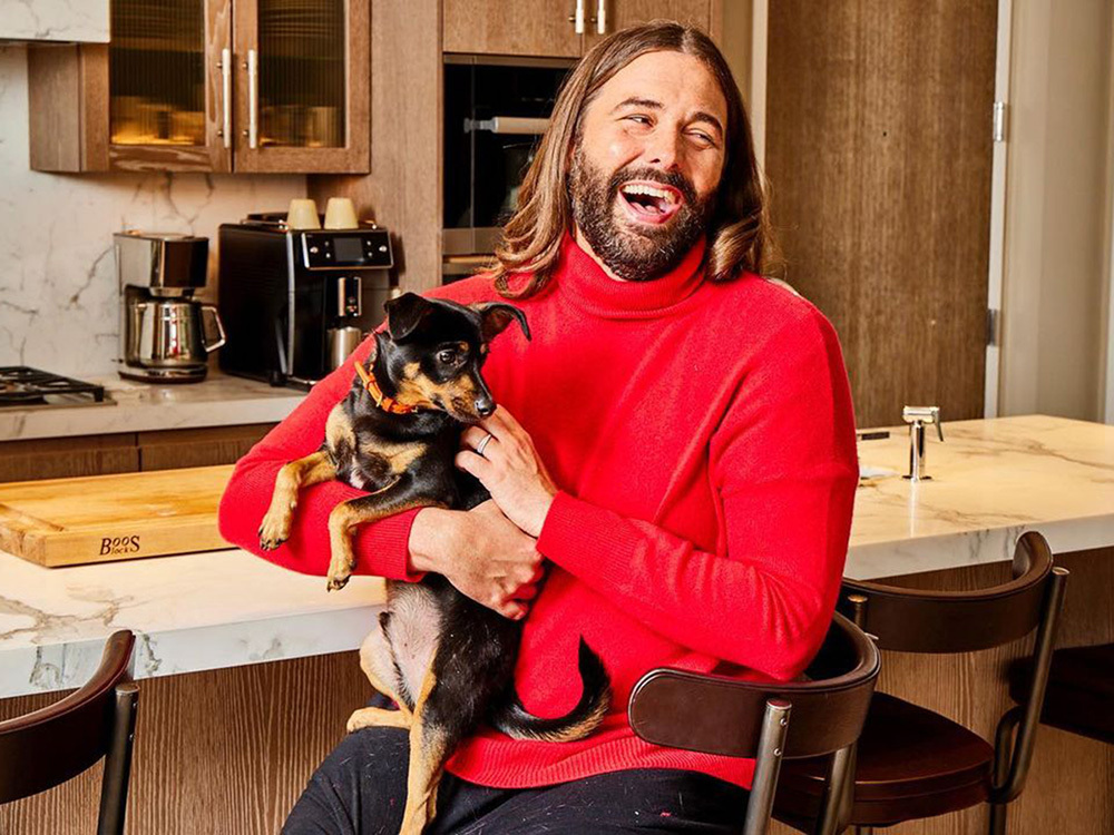 Jonthan Van Ness poses with a dog