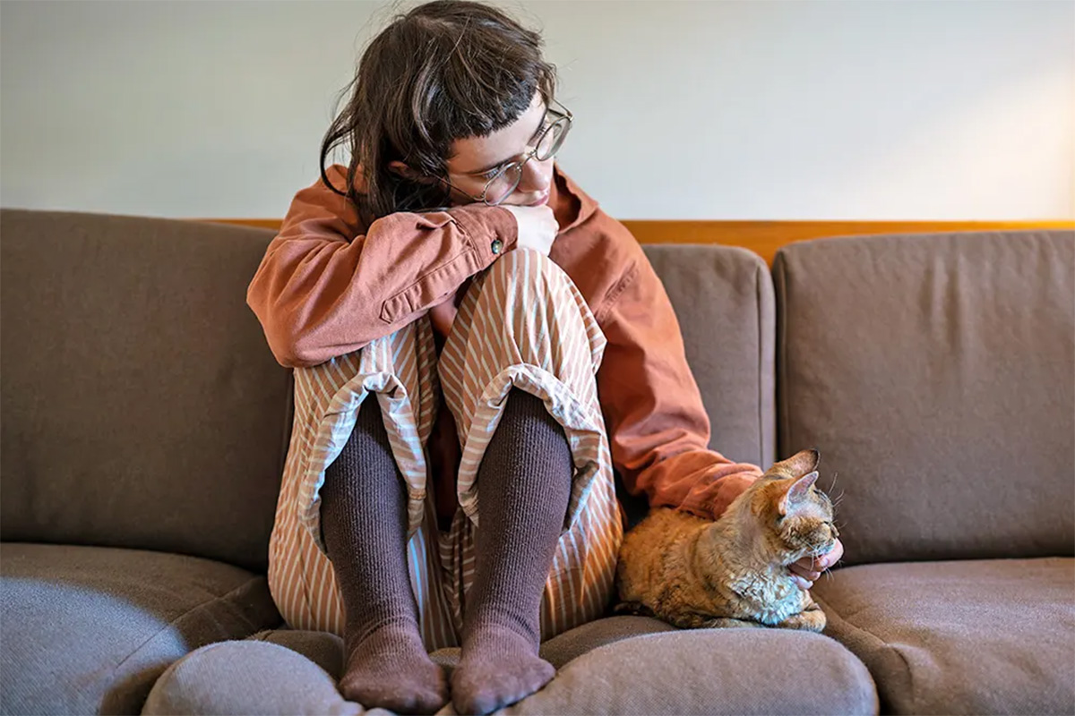 Sad person with a cat