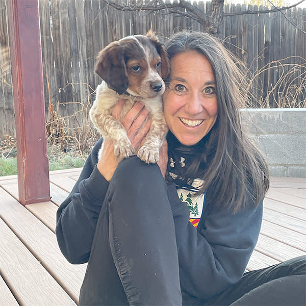 Karen London holding up a small dog