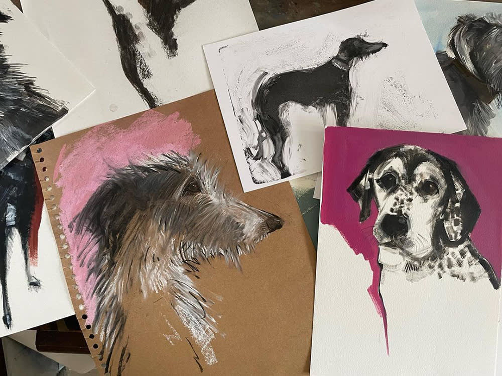 a pile of Sally Muir paintings of dogs