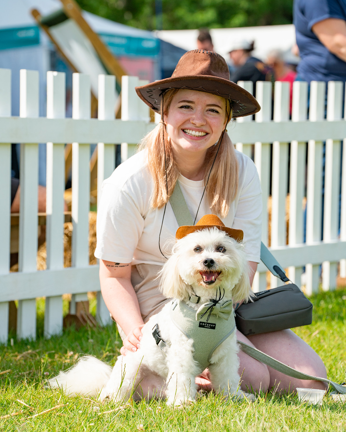 woman and dog at festival wearing hats