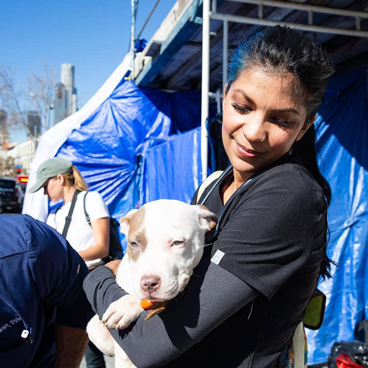 Genesis Rendon holding a pitbull puppy.