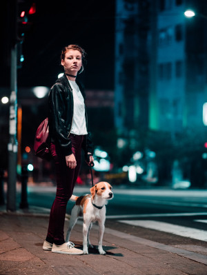 a dog walking with their parent at night