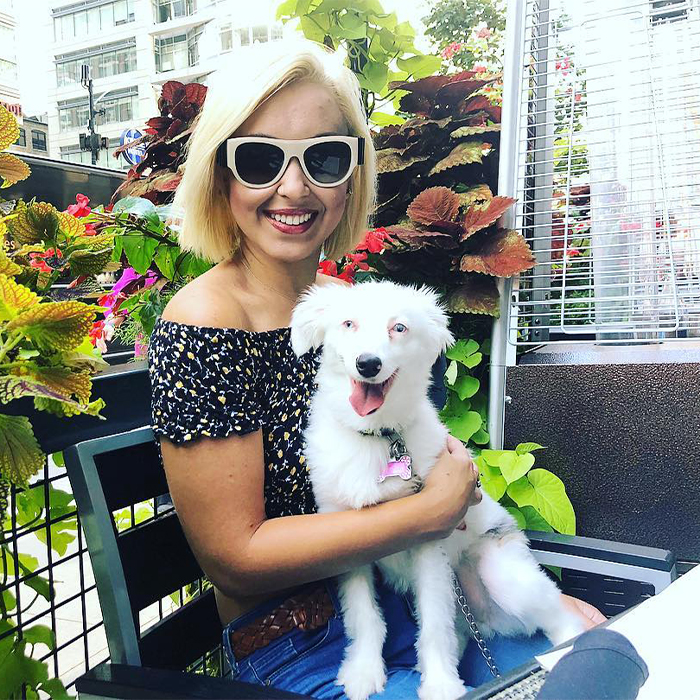 a woman and a small white dog 