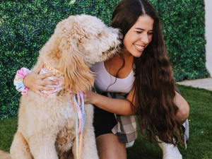 Woman with large dog wearing a Bundle x Joy dog bandana and leash.