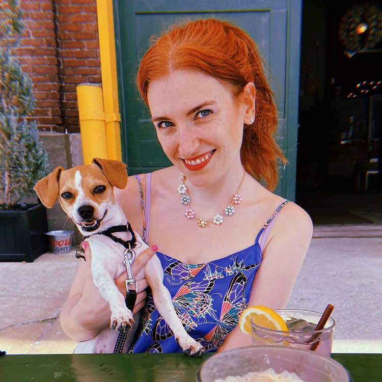 Artist, Siobhán Gallagher holding a dog. 