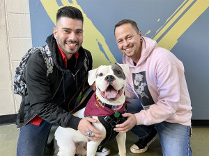 Elvis impersonator adopts black and white Pitbull dog.