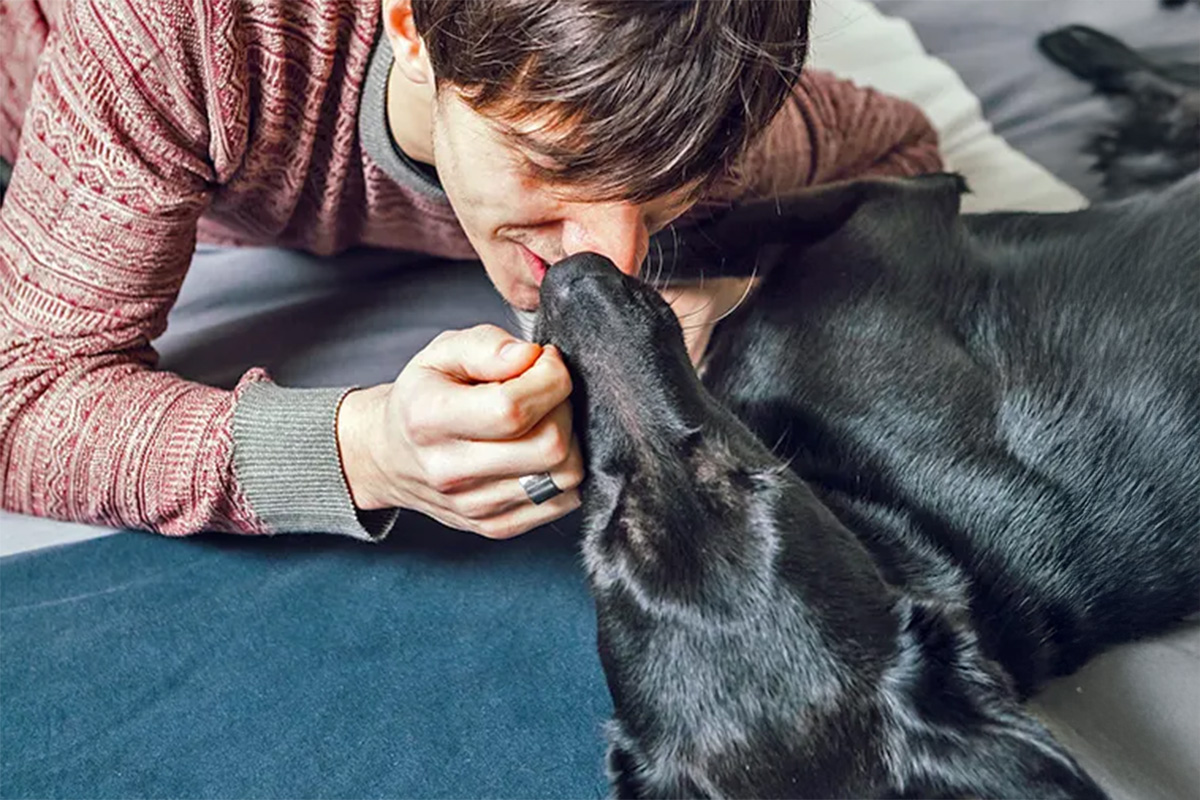 a man puts his nose against his dog’s nose
