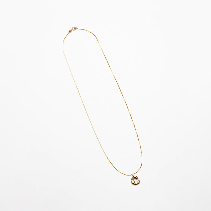 yellow gold necklace with puffy "C" charm
