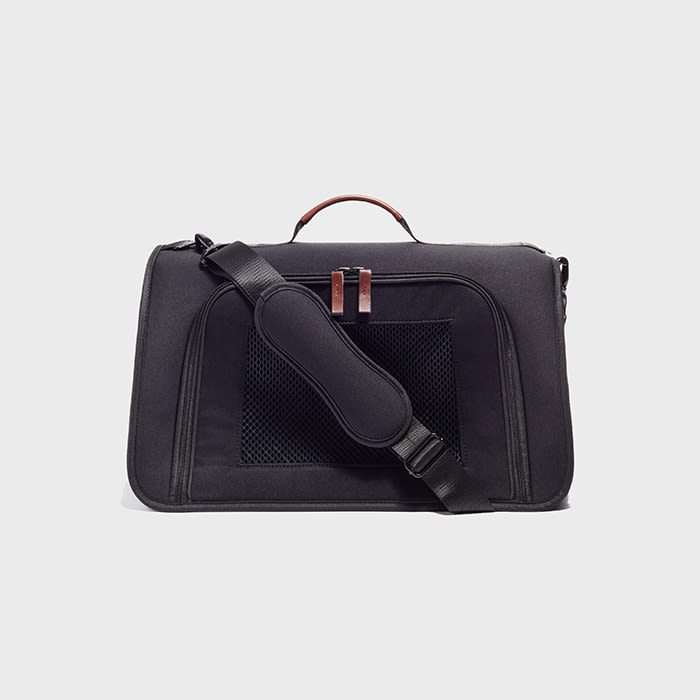 the pet carrier in black with a brown leather handle