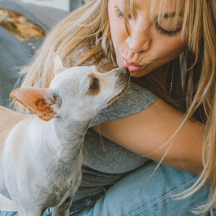 Kaley kisses her dog Opal 